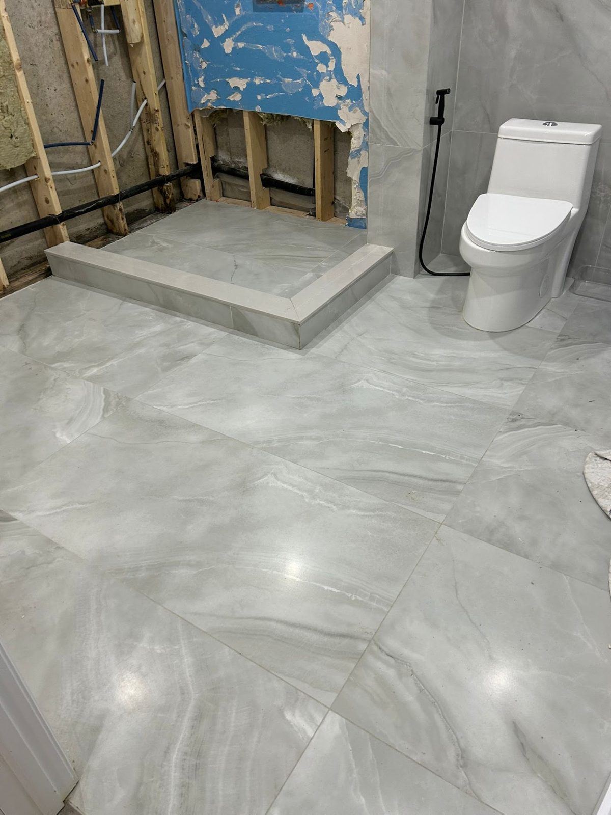 Bathroom rebuilt with new tile floor and shower after water damage